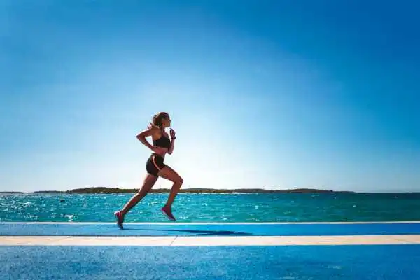 Woman running showing strong leg muscle Calne